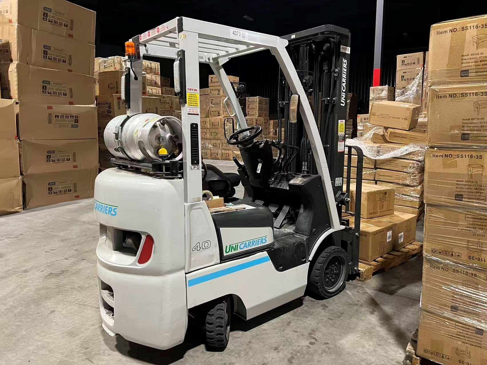 Forklift moving cartons inside a warehouse